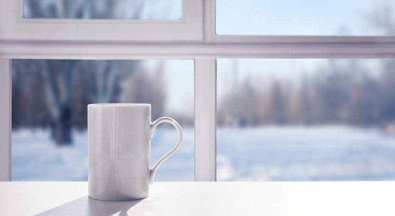 Mug in front of a window with a snowy view