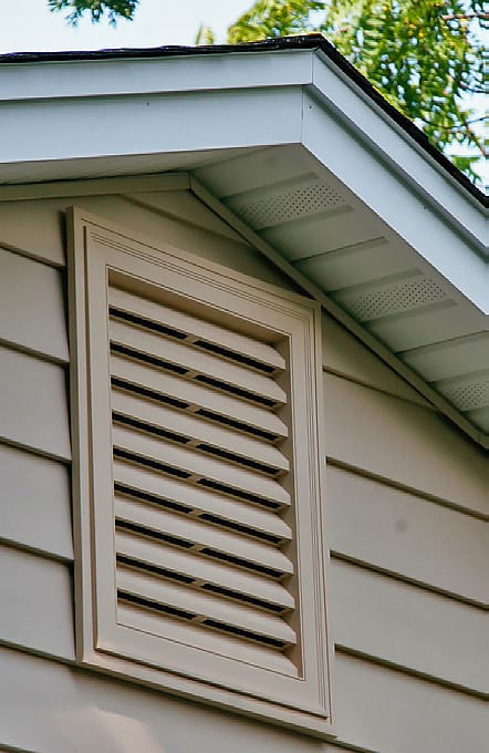 Tan hood vent on exterior of home