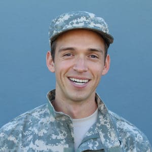 Military Man Smiling Isolated on Blue Background