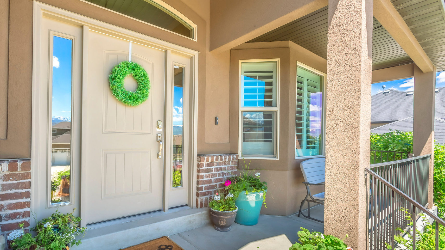 Panorama frame Front door with wreath transom window and sidelights at the façade of a home