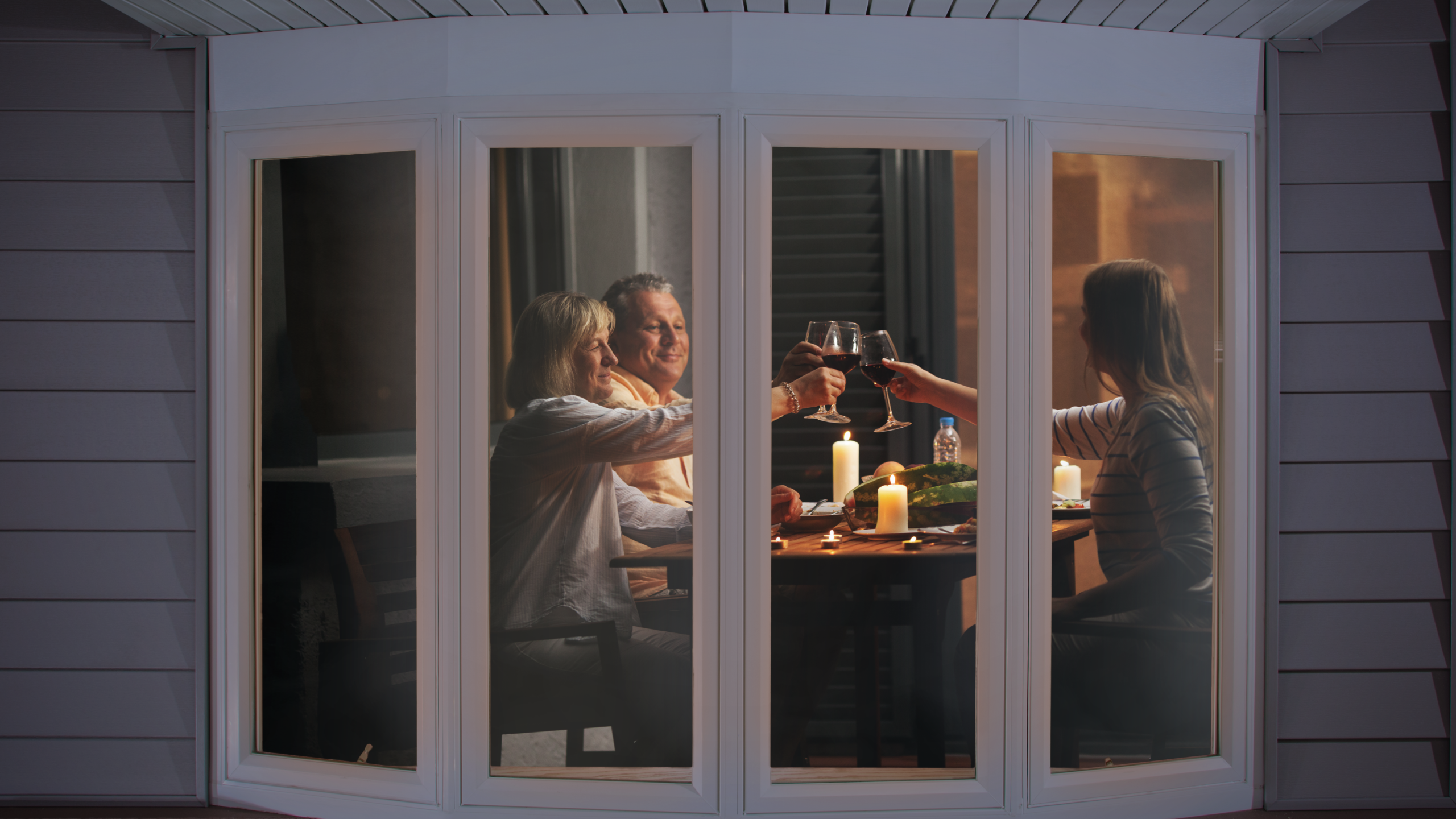 A family enjoying their comfortable interior behind energy-efficient replacement windows